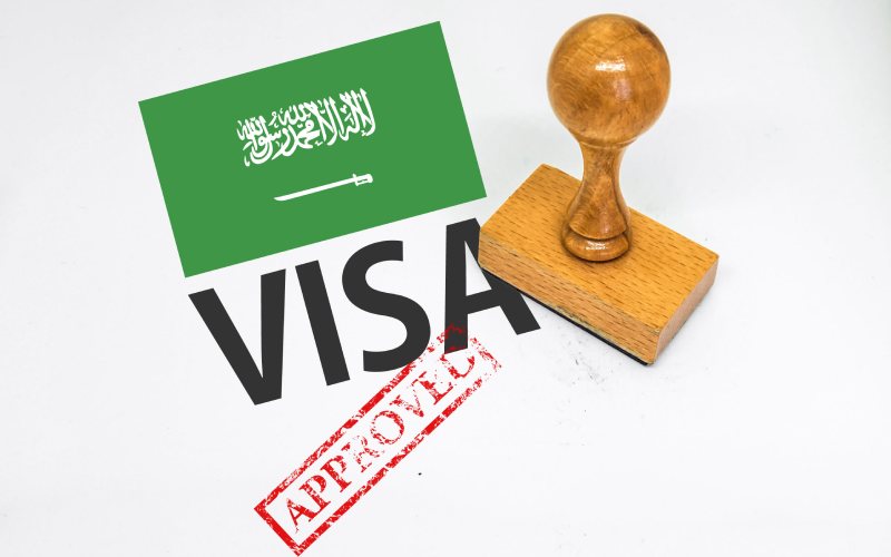 Saudi Arabia Visa Approved with Rubber Stamp and flag.
